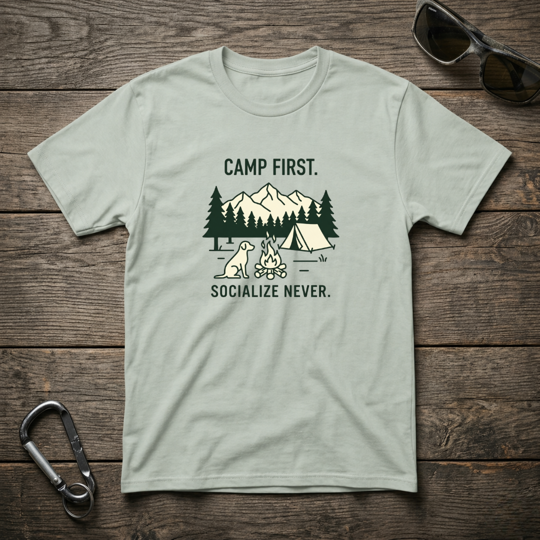 Graphic T-shirt from Designed For The Wild Co, Camp First Socialize Never in a garment-dyed fabric with bold logo print.