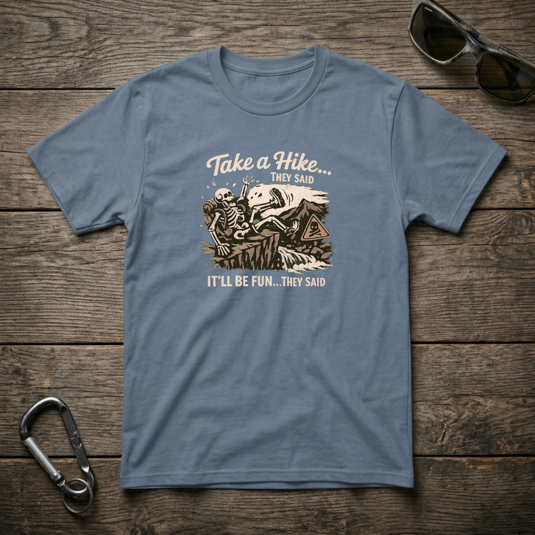 Blue garment-dyed graphic T-shirt by Designed For The Wild Co featuring outdoor-themed artwork for Take a Hike They Said.