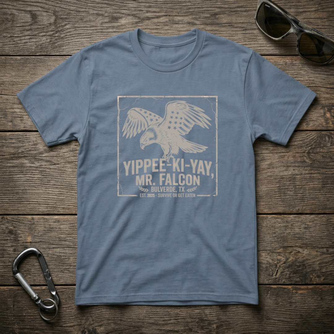 Blue graphic T-shirt by Designed For The Wild Co featuring a Yippee Ki Yay Mr. Falcon design on soft garment-dyed fabric.