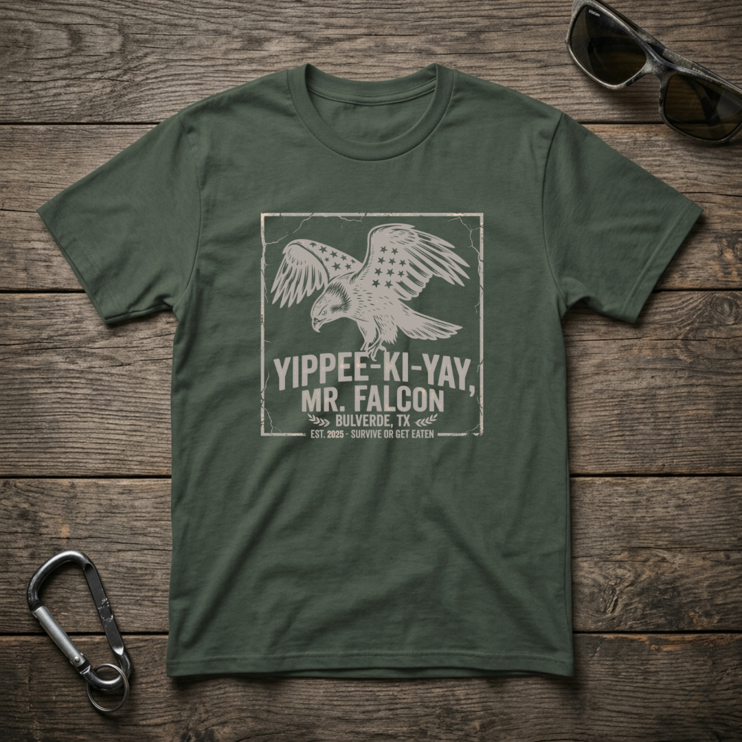 Blue spruce graphic T-shirt by Designed For The Wild Co featuring a "Yippee Ki Yay Mr. Falcon" design on garment-dyed fabric.