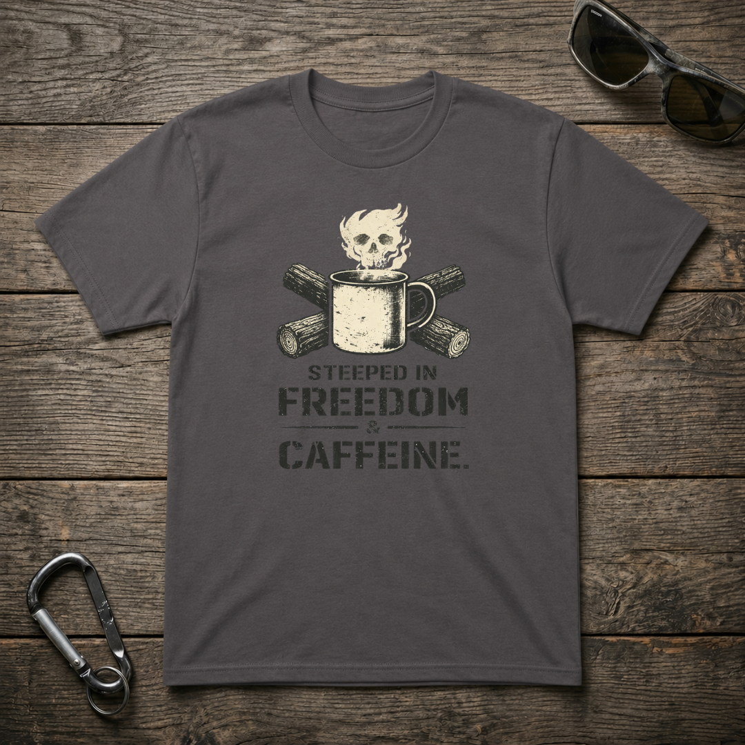 Charcoal graphic T-shirt from Designed For The Wild Co featuring bold "Steeped In Freedom & Caffeine" design on front.