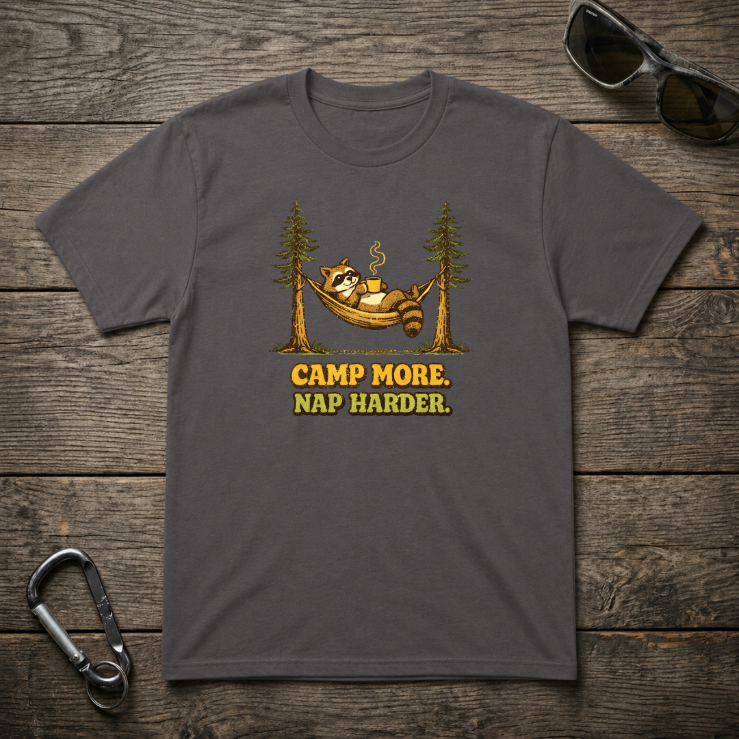 Charcoal graphic T-shirt by Designed For The Wild Co with "Camp More, Nap Harder" text and outdoor-themed design.