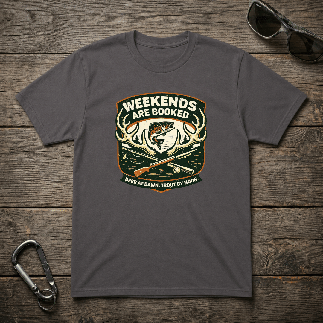 Charcoal-colored graphic T-shirt from Designed For The Wild Co with "Weekends Are Booked Camping" print, heavyweight cotton fabric.