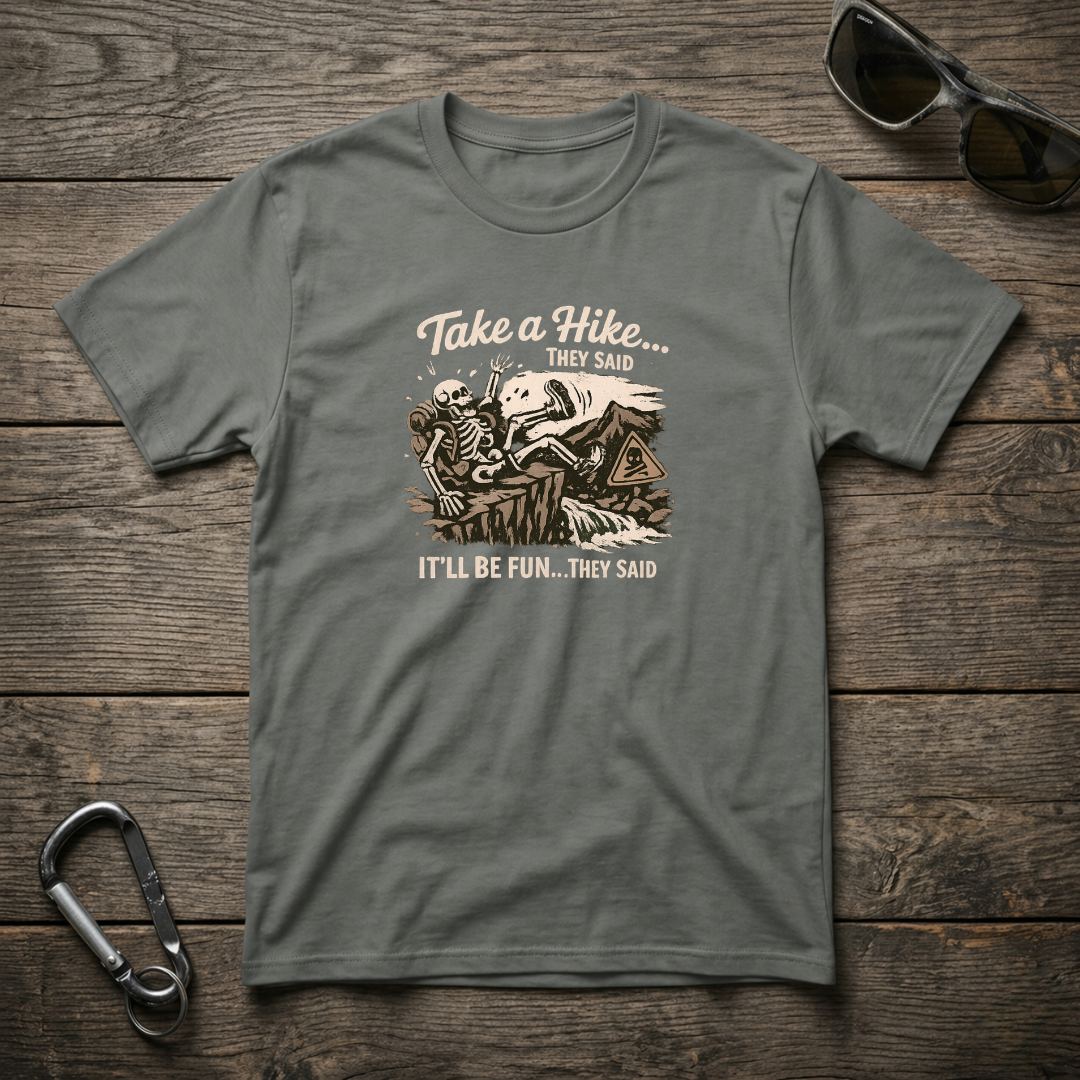 Gray graphic T-shirt by Designed For The Wild Co featuring a "Take a Hike They Said" design on soft, garment-dyed fabric.