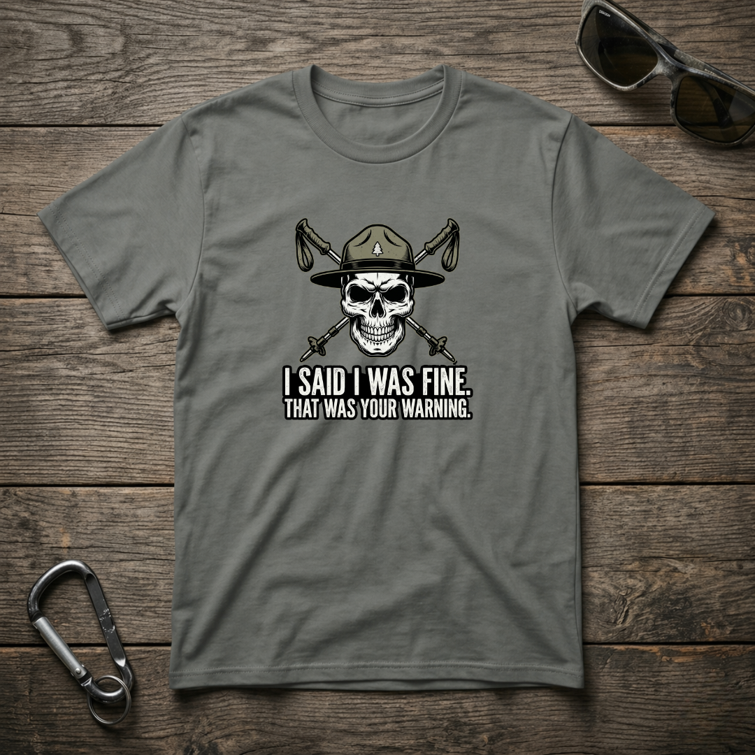 Grey graphic T-shirt by Designed For The Wild Co with "I Said I Was Fine" text, garment-dyed cotton fabric, casual style.