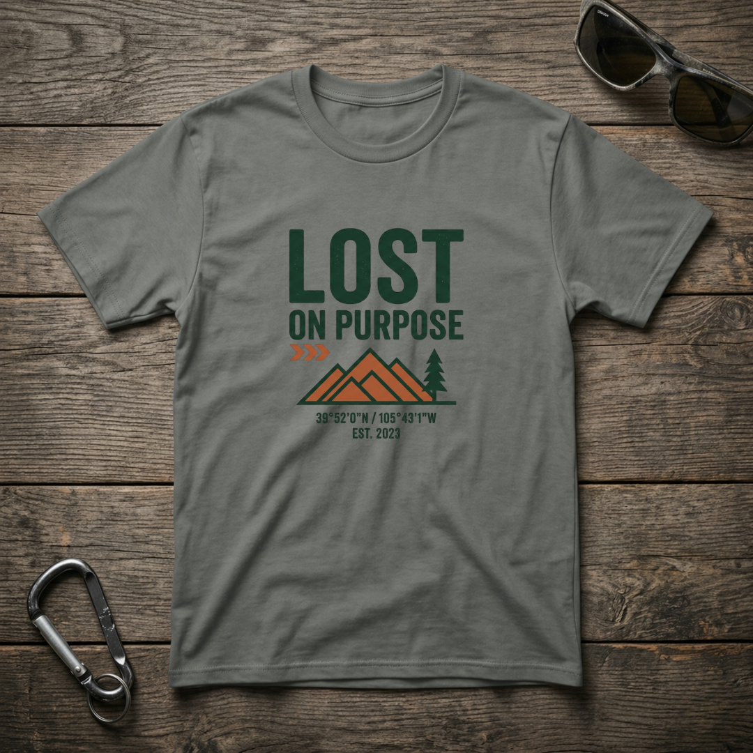 Gray graphic T-shirt by Designed For The Wild Co with "Lost on Purpose" text and casual, garment-dyed fabric.