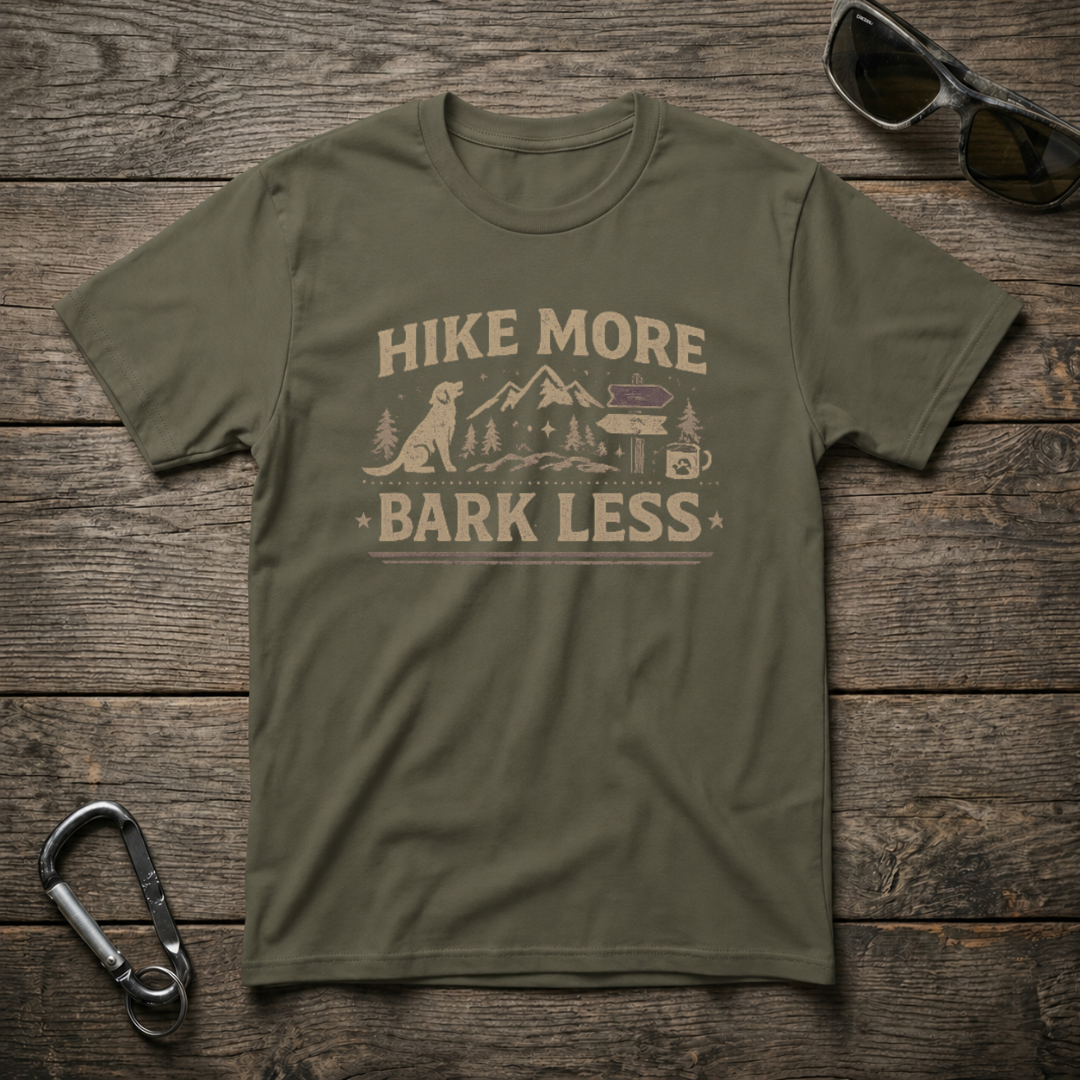Military green graphic T-shirt by Designed For The Wild Co featuring "Hike More, Bark Less" slogan on soft cotton fabric.