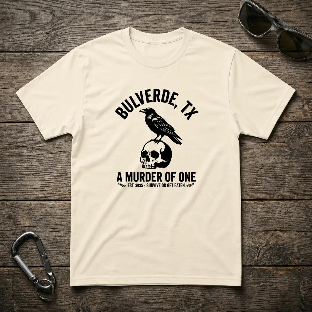 Designed For The Wild Co Murder Of One heavyweight graphic T-shirt with bold print, shown on a natural background.