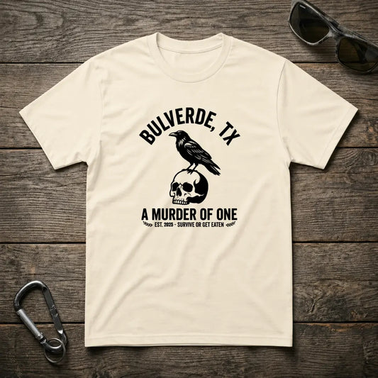 Designed For The Wild Co Murder Of One heavyweight graphic T-shirt with bold print, shown on a natural background.