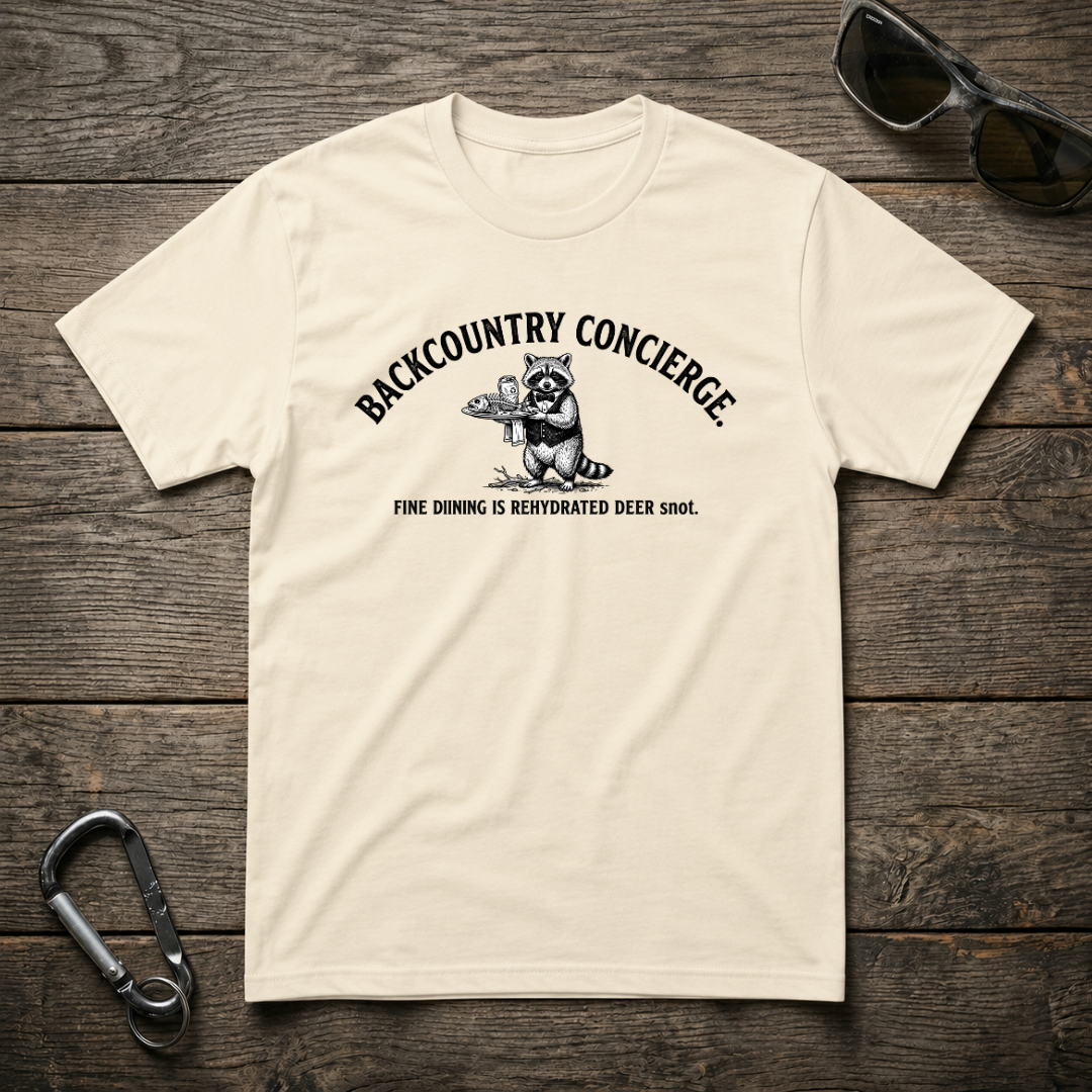Designed For The Wild Co Backcountry Concierge Heavyweight Graphic T-Shirt shown in natural fabric with bold front design.