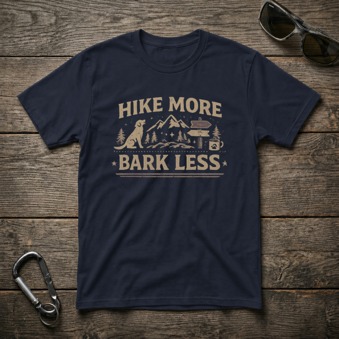Navy graphic T-shirt by Designed For The Wild Co with "Hike More, Bark Less" text and mountain and dog illustrations.