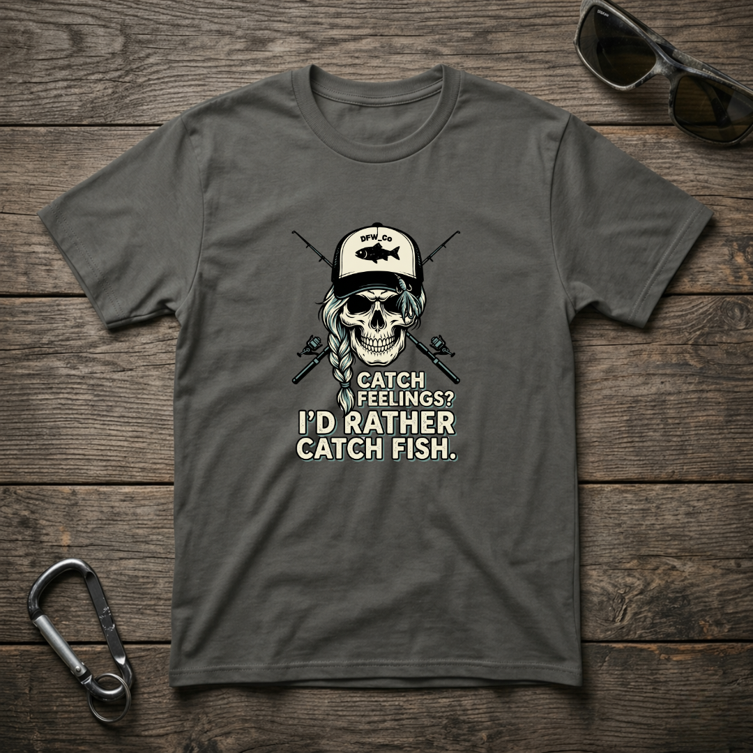 Graphic T-Shirt by Designed For The Wild Co featuring "I'd Rather Catch Fish" print on a garment-dyed fabric.
