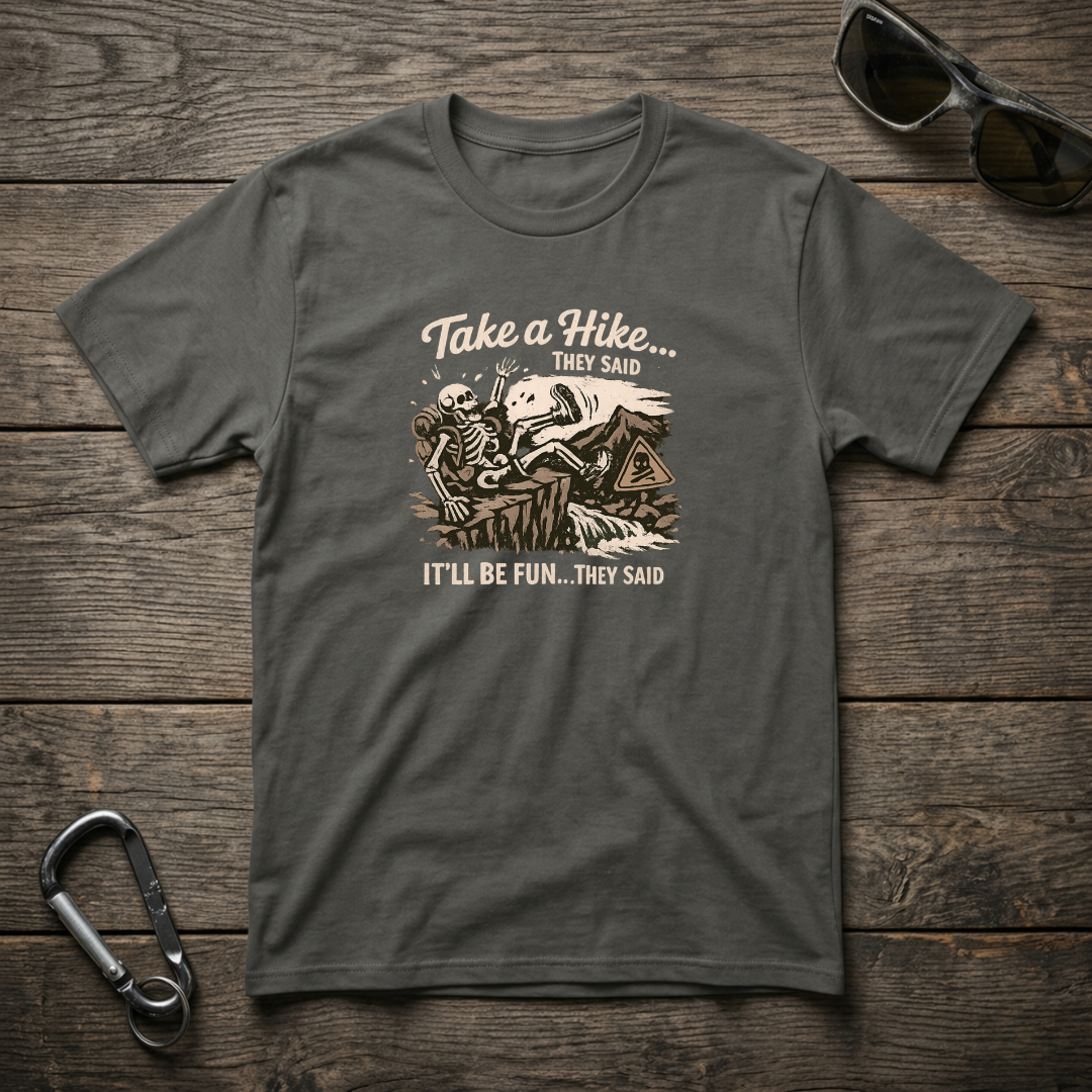 Graphic T-Shirt by Designed For The Wild Co featuring "Take a Hike They Said" text in a garment-dyed fabric, shown in pepper color.