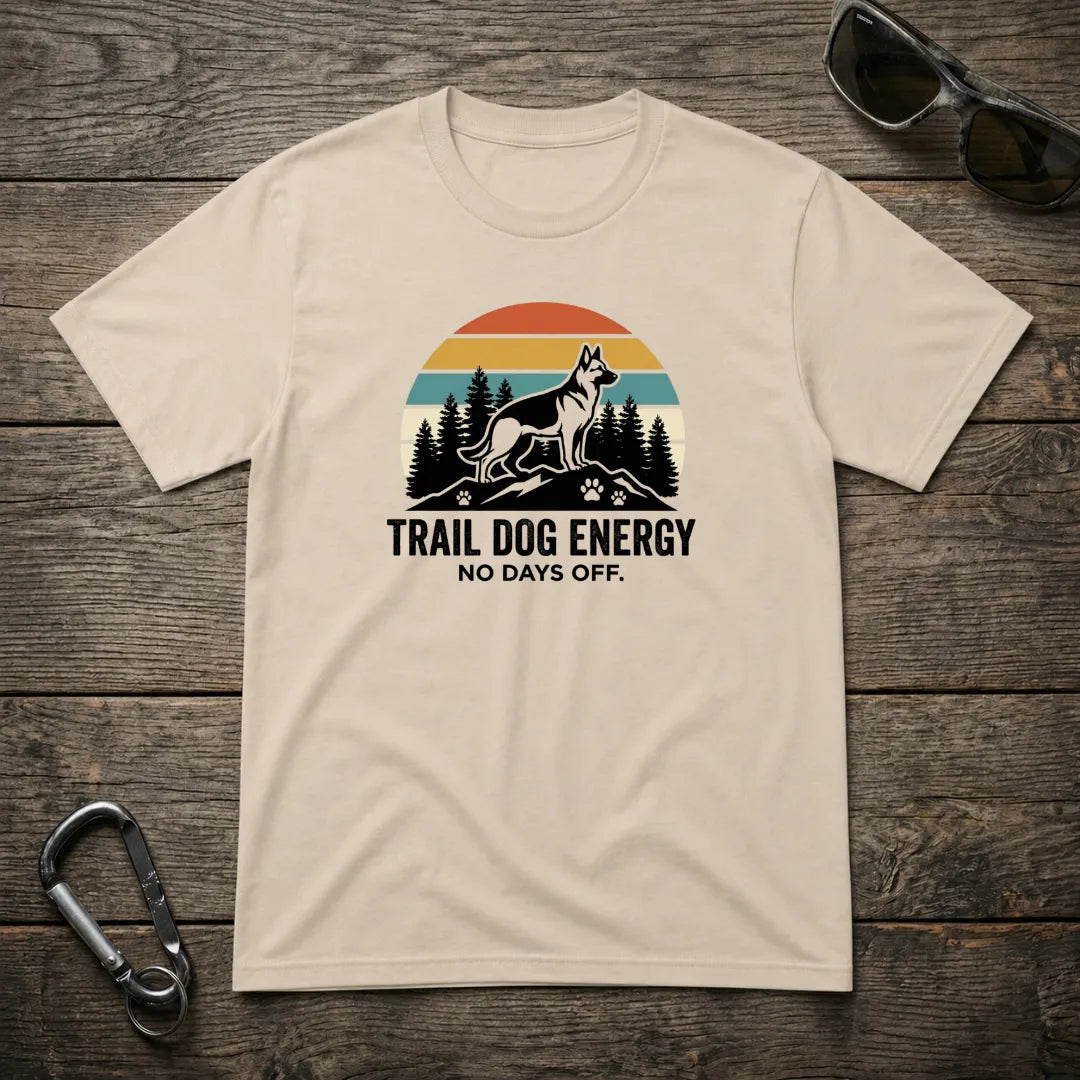 Trail Dog Energy heavyweight graphic T-shirt by Designed For The Wild Co, featuring outdoor-inspired dog design on sand-colored fabric.