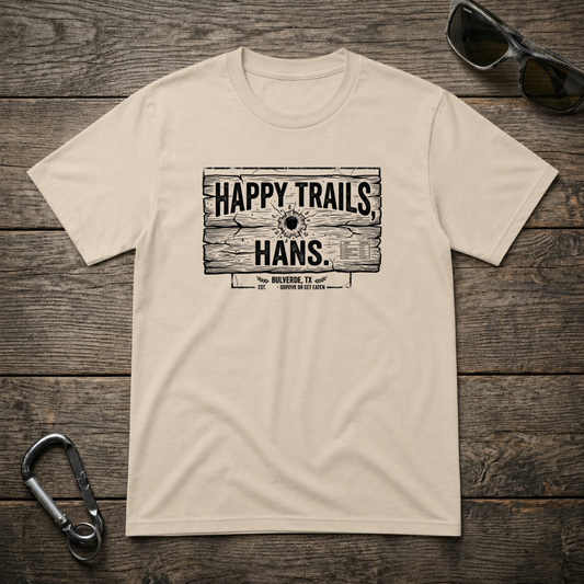 Happy Trails Hans heavyweight graphic T-shirt by Designed For The Wild Co featuring outdoor-themed artwork on a sand-colored fabric.