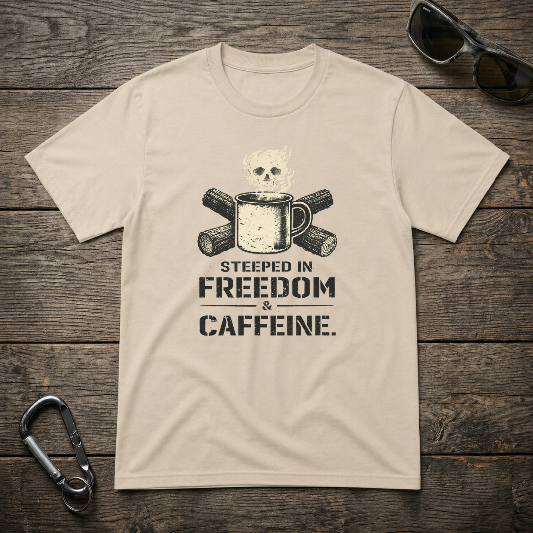 Graphic T-Shirt by Designed For The Wild Co featuring "Steeped In Freedom & Caffeine" design on a light-colored fabric.