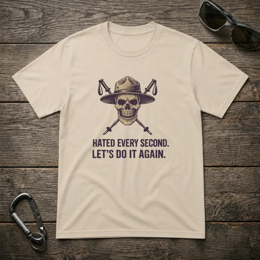 Graphic heavyweight T-shirt by Designed For The Wild Co featuring bold text "I Hated Every Second" on a sand-colored fabric.