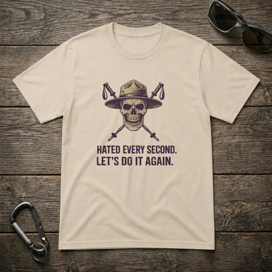 Graphic heavyweight T-shirt by Designed For The Wild Co featuring bold text "I Hated Every Second" on a sand-colored fabric.