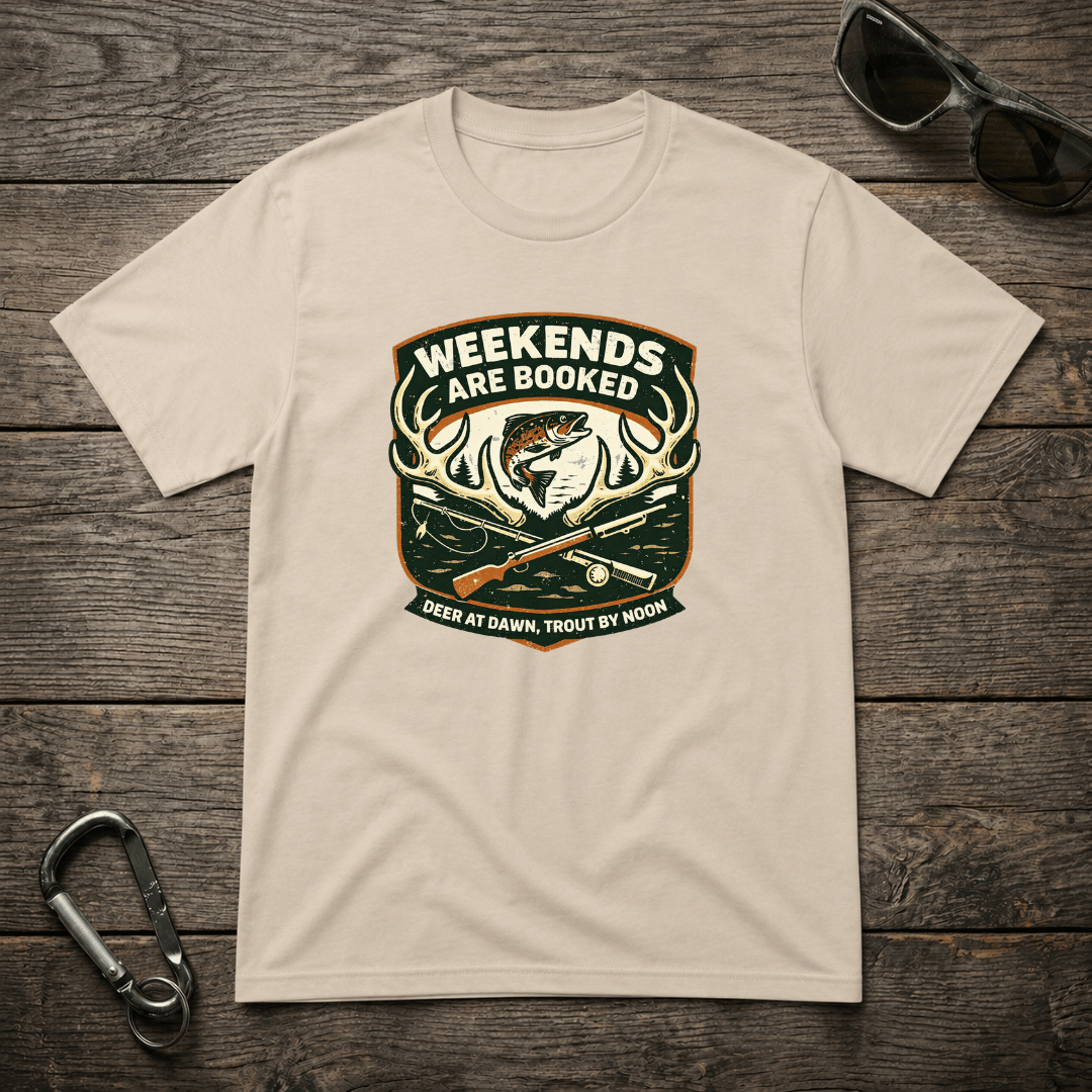 Graphic T-shirt from Designed For The Wild Co featuring "Weekends Are Booked Camping" design on a heavyweight fabric in sand color.