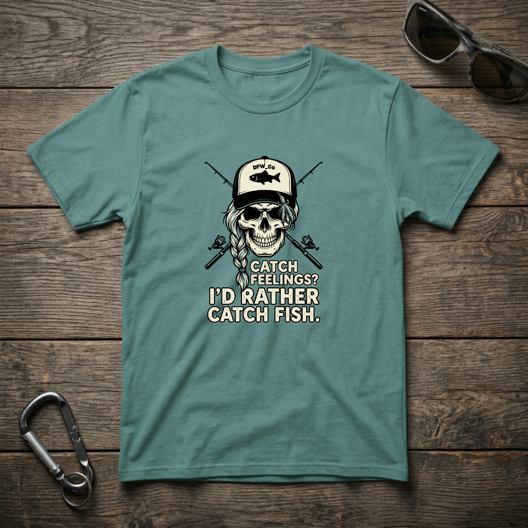 Seafoam-colored graphic T-shirt by Designed For The Wild Co featuring a fish-catching design on soft, garment-dyed fabric.