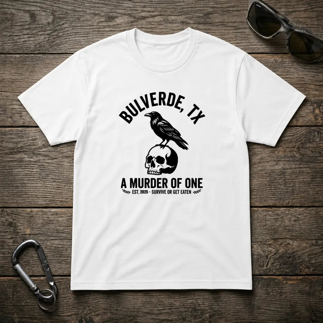 White graphic t-shirt by Designed For The Wild Co featuring bold "Murder Of One" design on heavyweight cotton fabric.